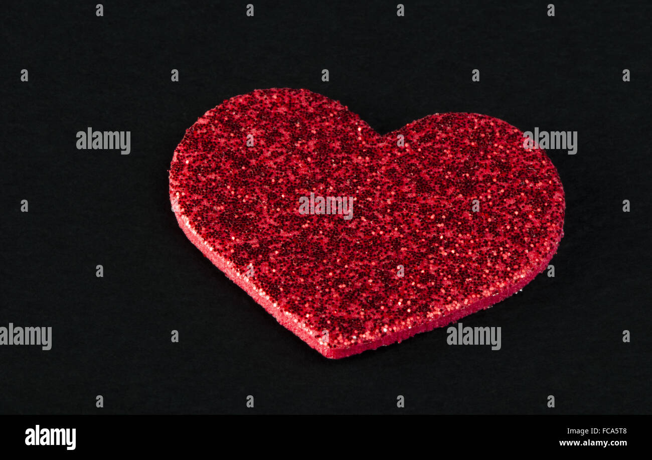 Red shiny hearts on black background Stock Photo - Alamy