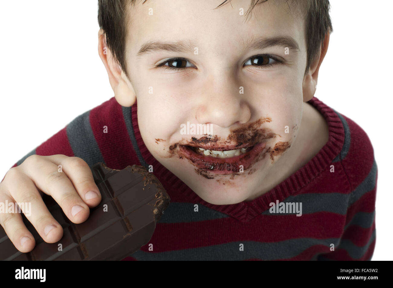 Smiling little boy eating chocolate Stock Photo Alamy