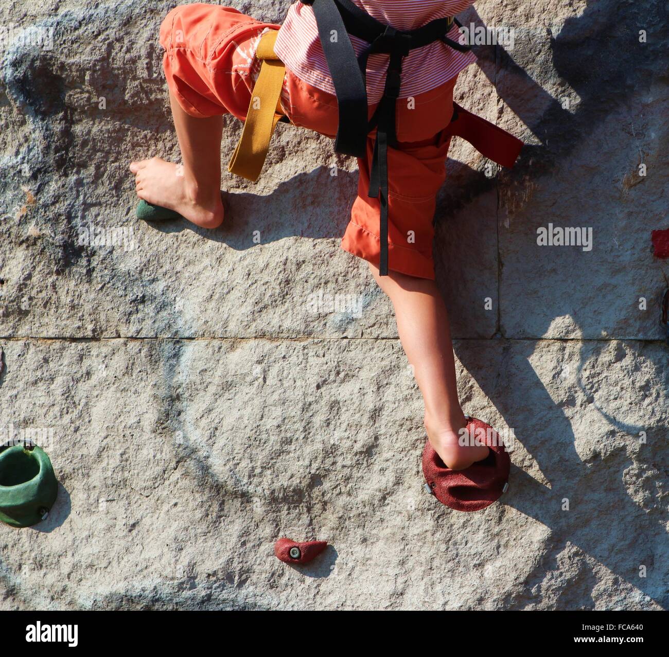 Child on a climbing face Stock Photo
