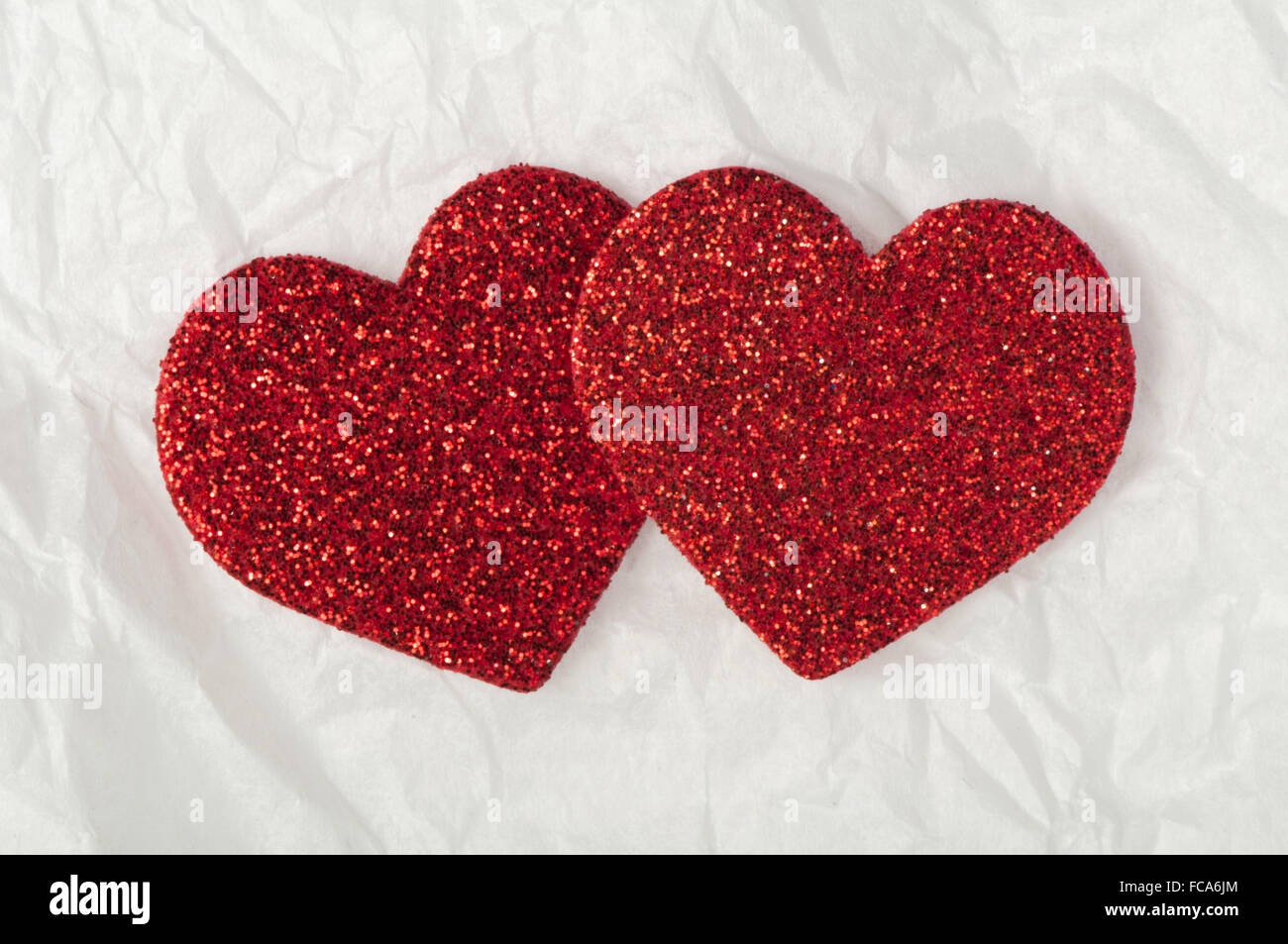 Shiny red hearts on white paper Stock Photo - Alamy