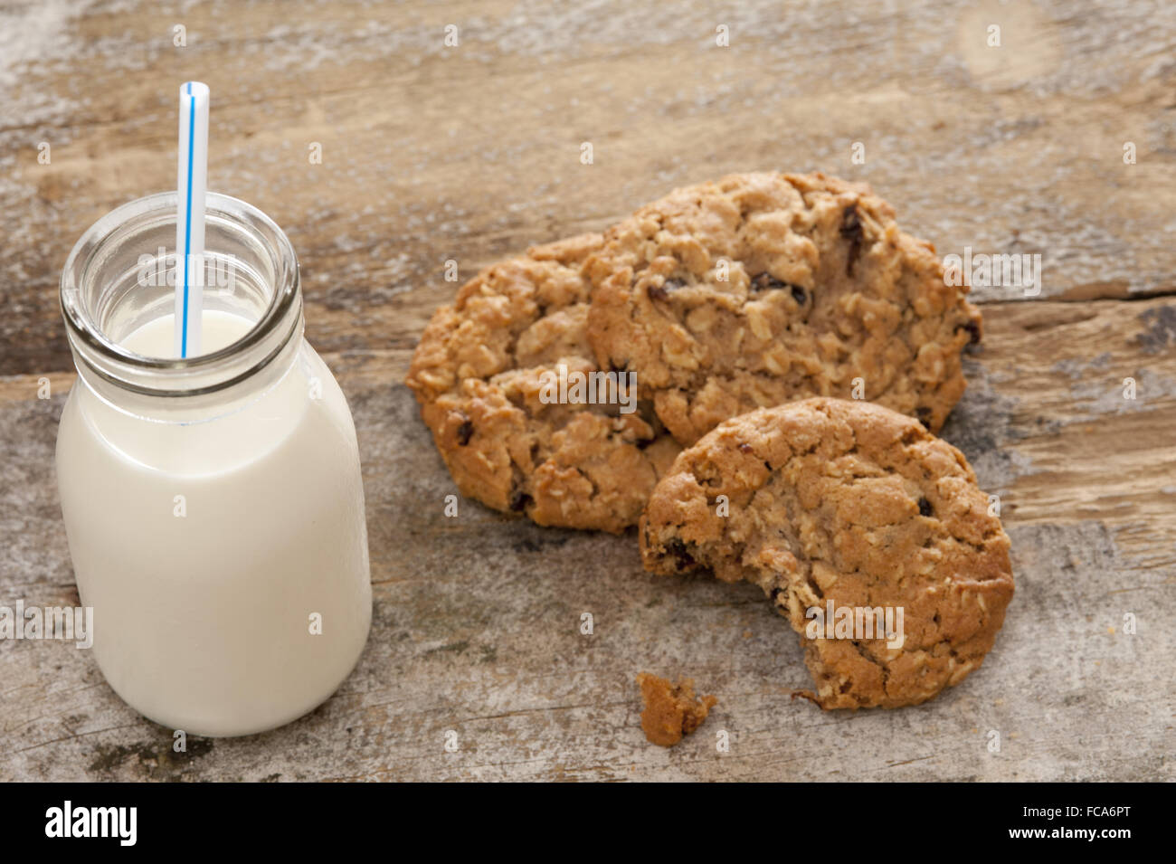 Bottle of milk with half eaten cookies Stock Photo