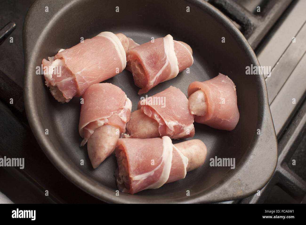 Cooking pigs in blankets Stock Photo