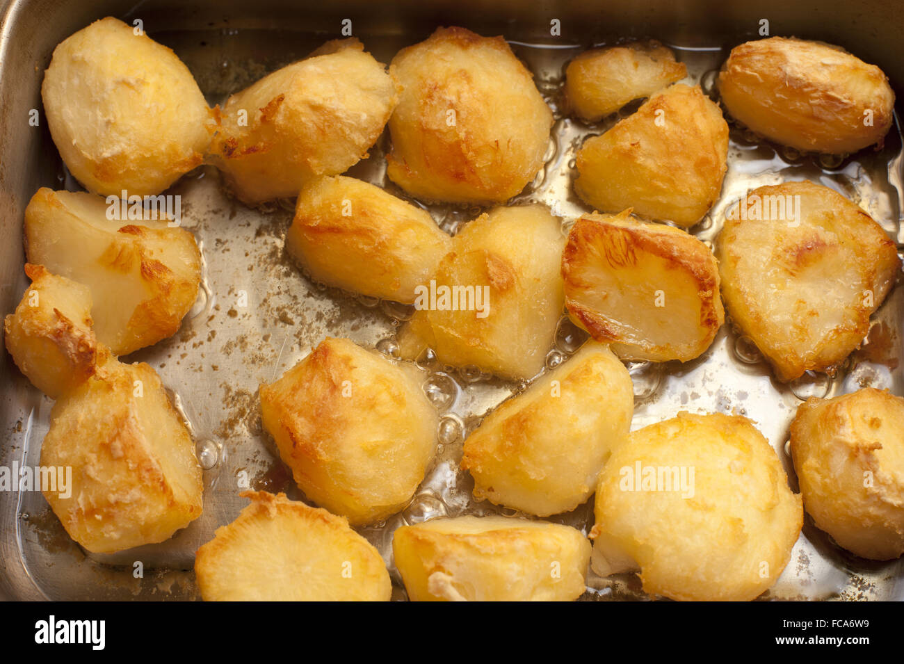 Background of delicious golden roast potatoes Stock Photo