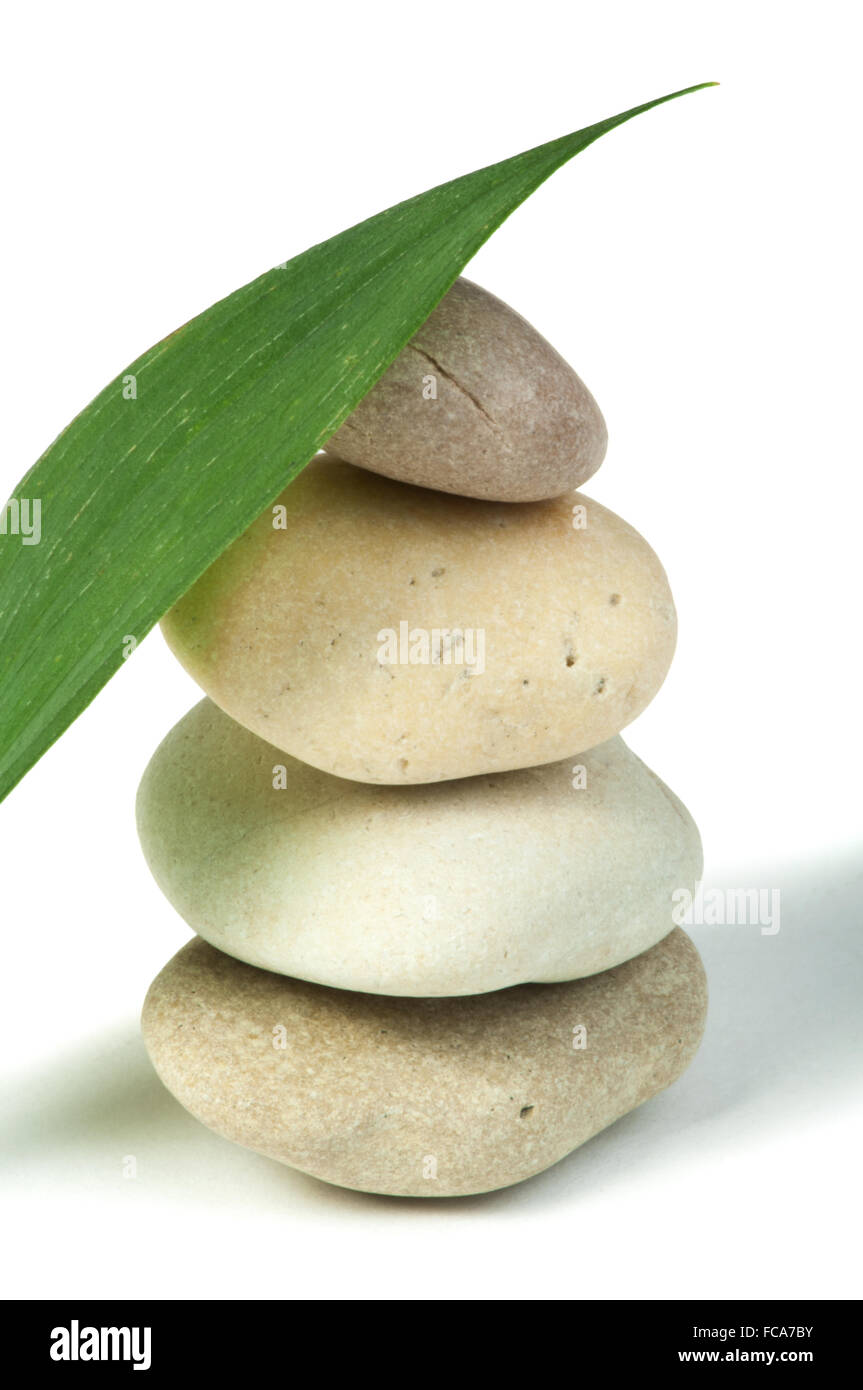 Stacked stones and green leafs Stock Photo - Alamy