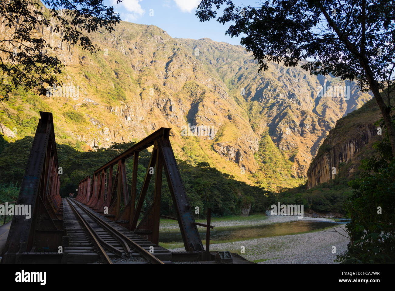 Iron bridge on the railroad track crossing jungle and Urubamba river, connecting Machu Picchu village to hydroelectric station,  Stock Photo