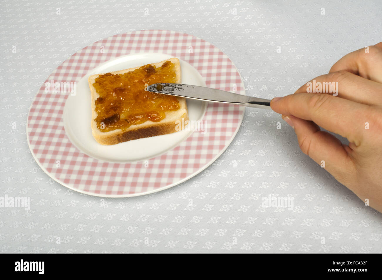 Spread jam on bread Stock Photo Alamy