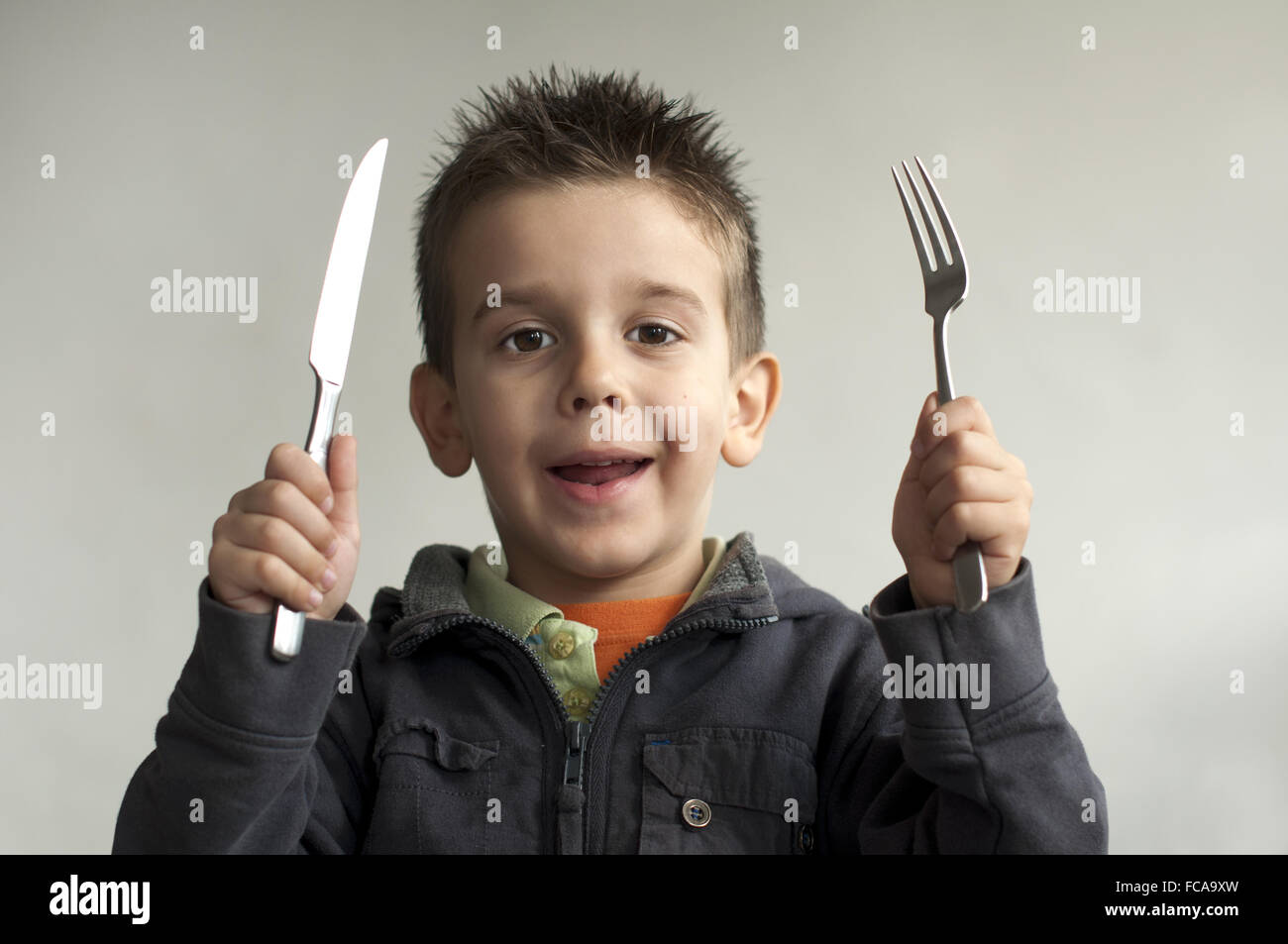 Child with a knife and fork Stock Photo Alamy