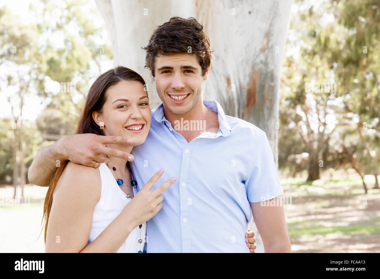Young happy couple in the park in the summer Stock Photo - Alamy