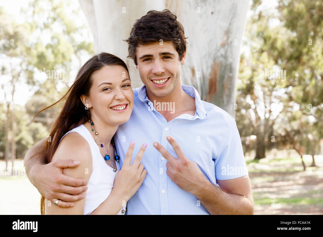 Young happy couple in the park in the summer Stock Photo - Alamy