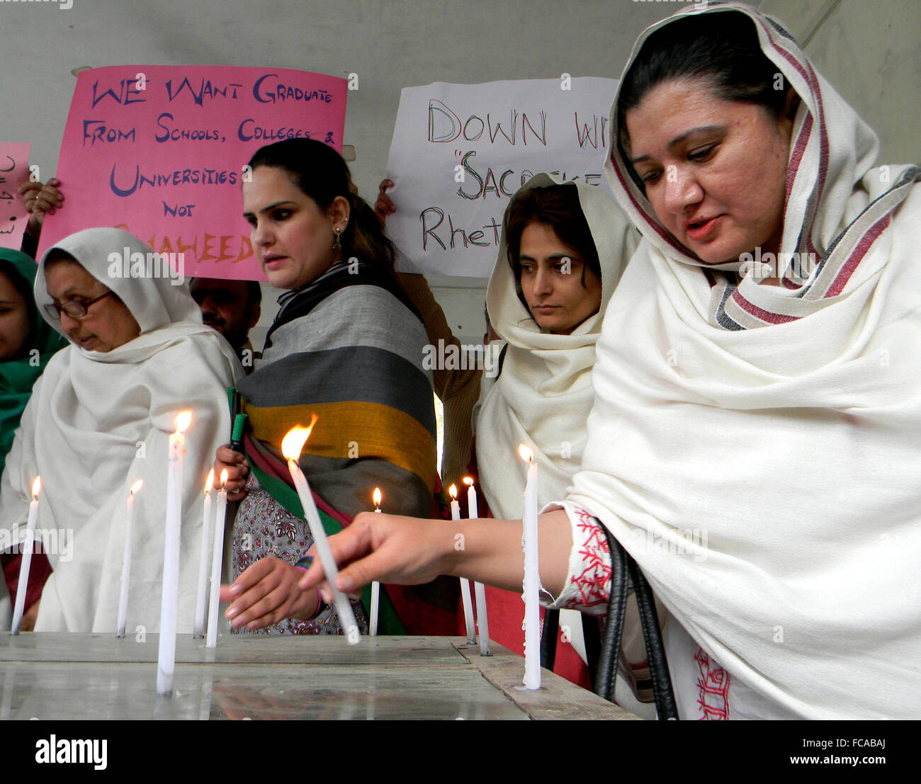 Peshawar. 21st Jan, 2016. Pakistani people light candles as they protest against the militants attack on Bacha Khan University in northwest Pakistan's Peshawar on Jan. 21, 2016. Officials said death toll from the deadly attack on Bacha Khan University in Charsadda district has reached 21. Credit:  Ahmad Sidique/Xinhua/Alamy Live News Stock Photo