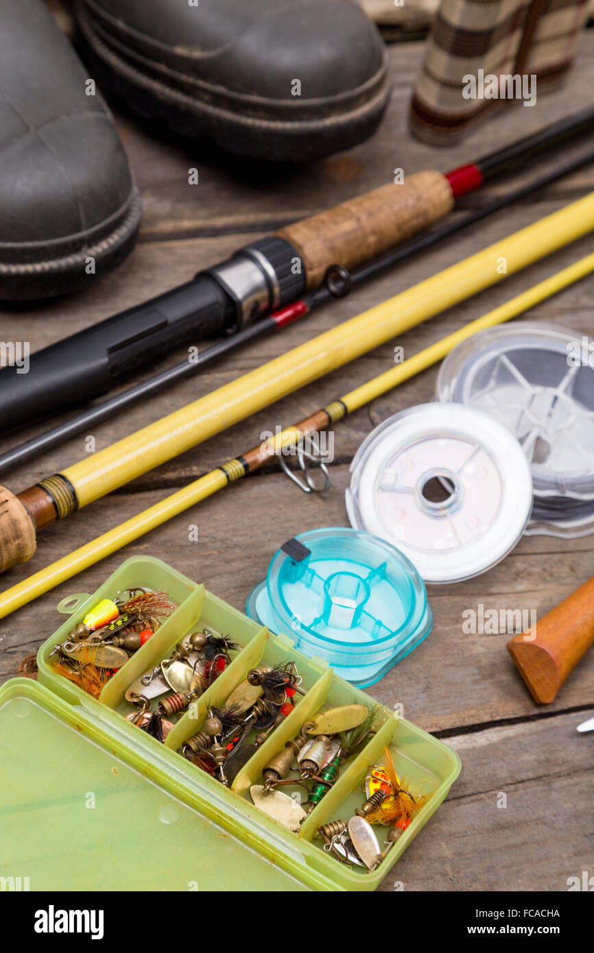 different fishing tackles for journey on background of wooden boards
