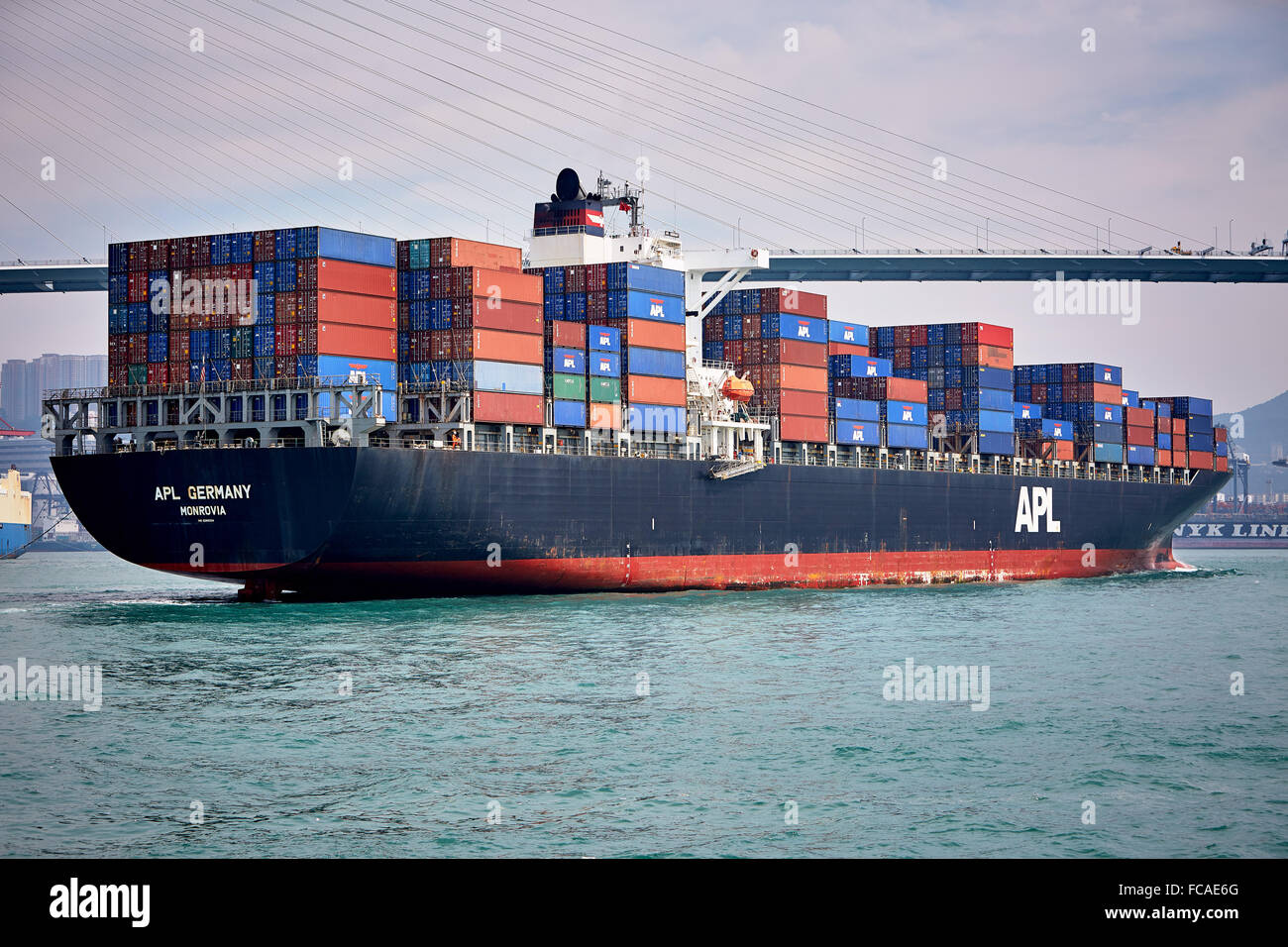 A fully laden container ship cruises the Lamma East Channel on its way to the Tsing Yi container
