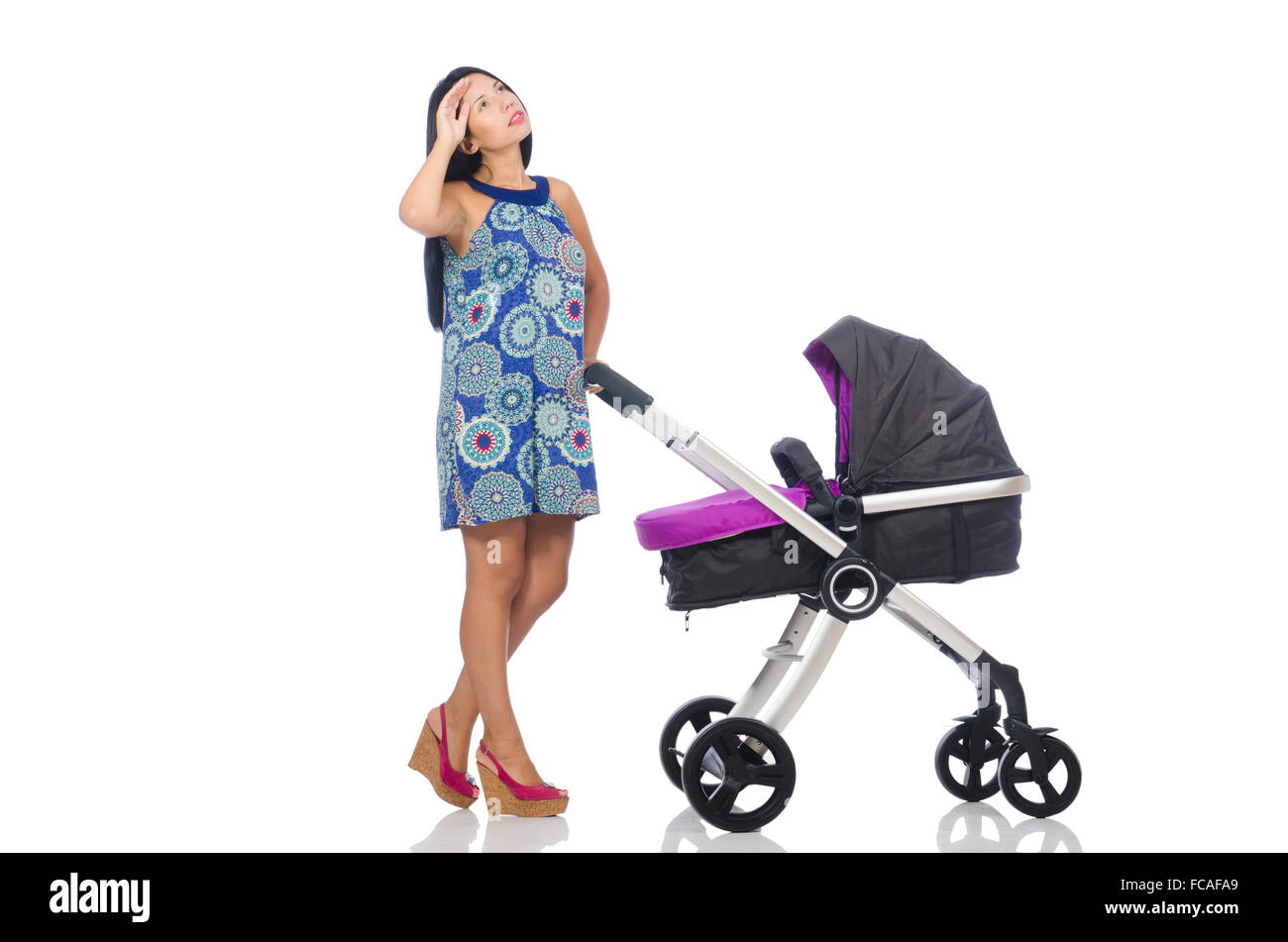 Happy mom with her baby in pram Stock Photo