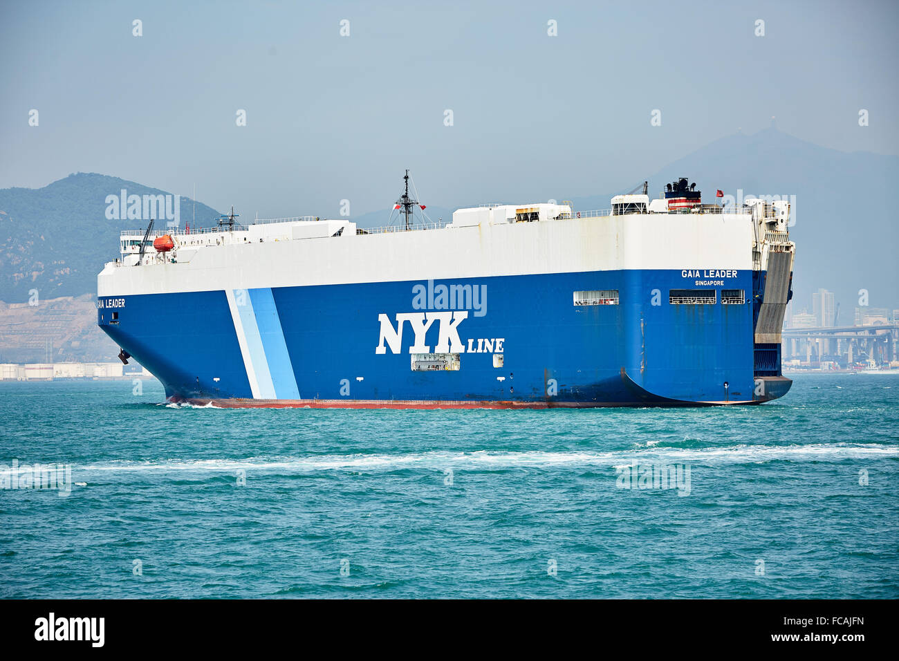 A RoRo ship carrying vehicles sails in the Lamma East Channel heading for the Tsing Yi container terminal in Hong Kong. Stock Photo