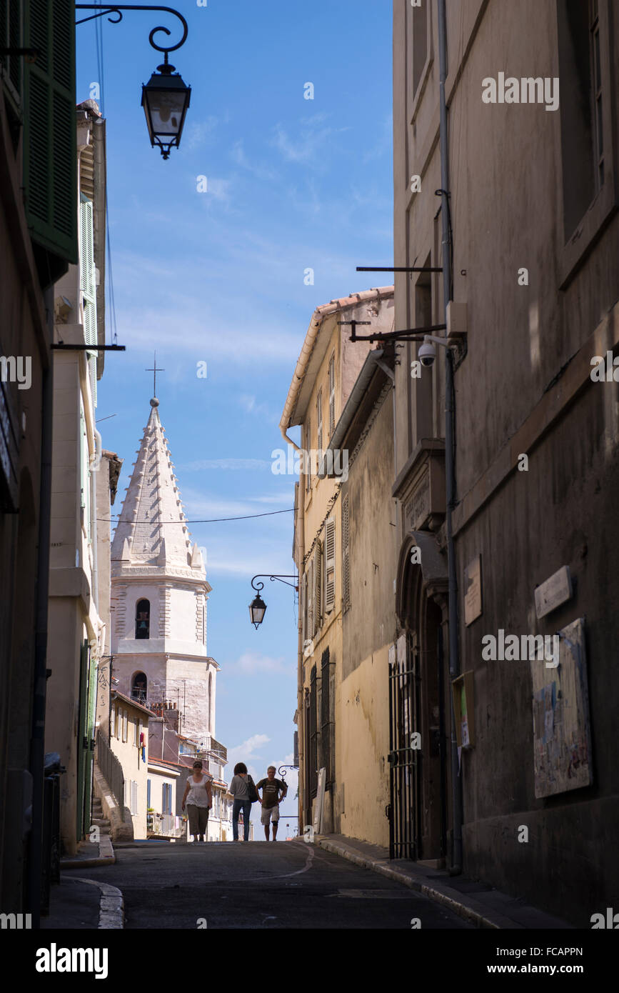 Three people walking in the Panier neighborhood of Marseille, France. Stock Photo