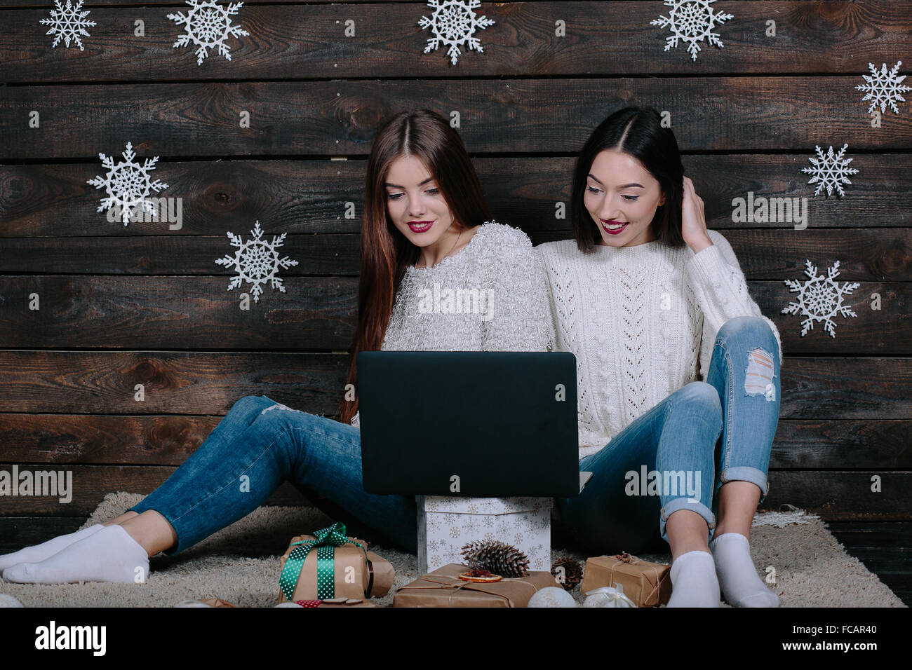 Two beautiful girls siting on the floor Stock Photo - Alamy