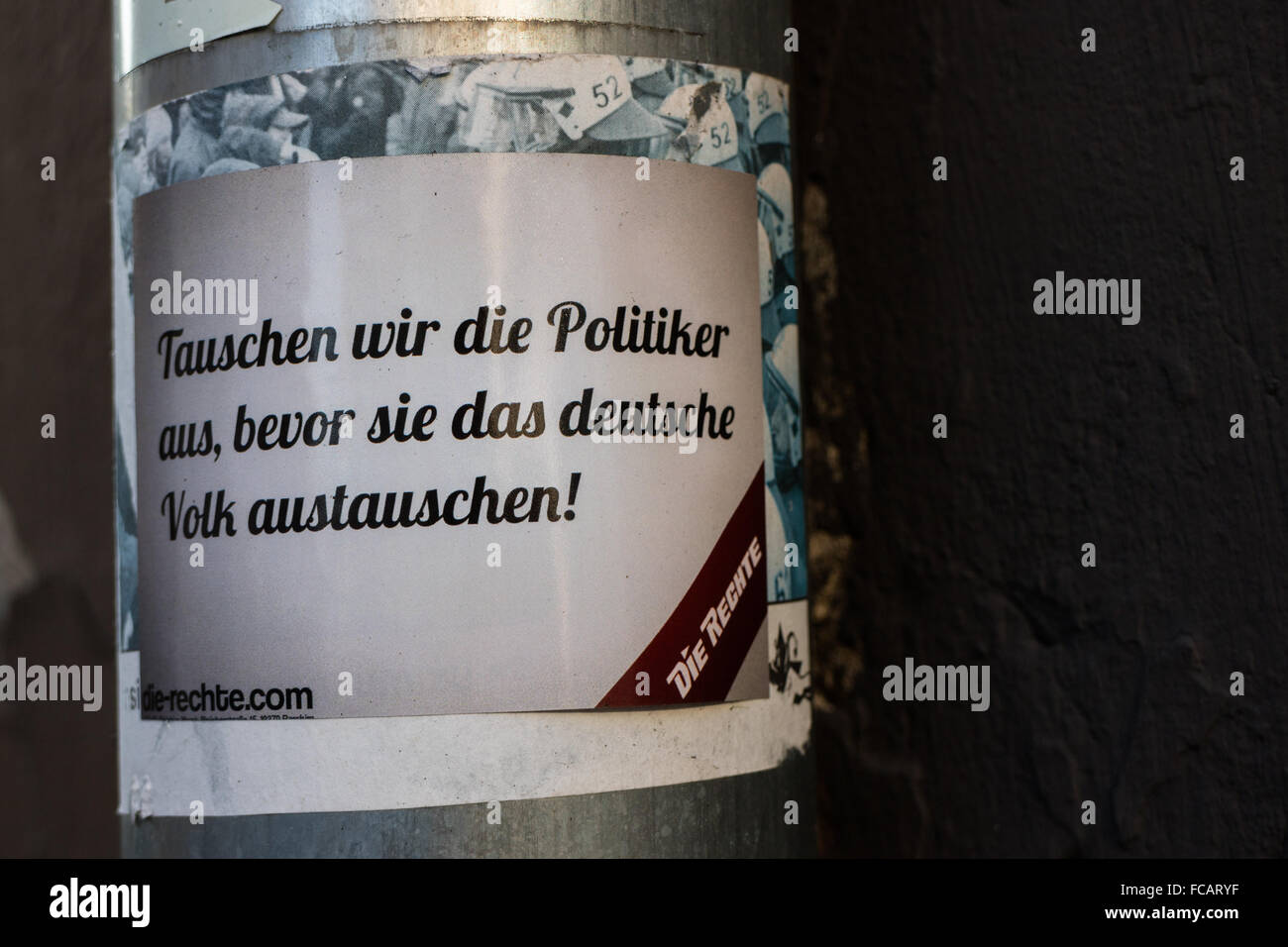 A German right wing lamp post sticker says 'We will exchange the politicians before replacing the German people.' Stock Photo