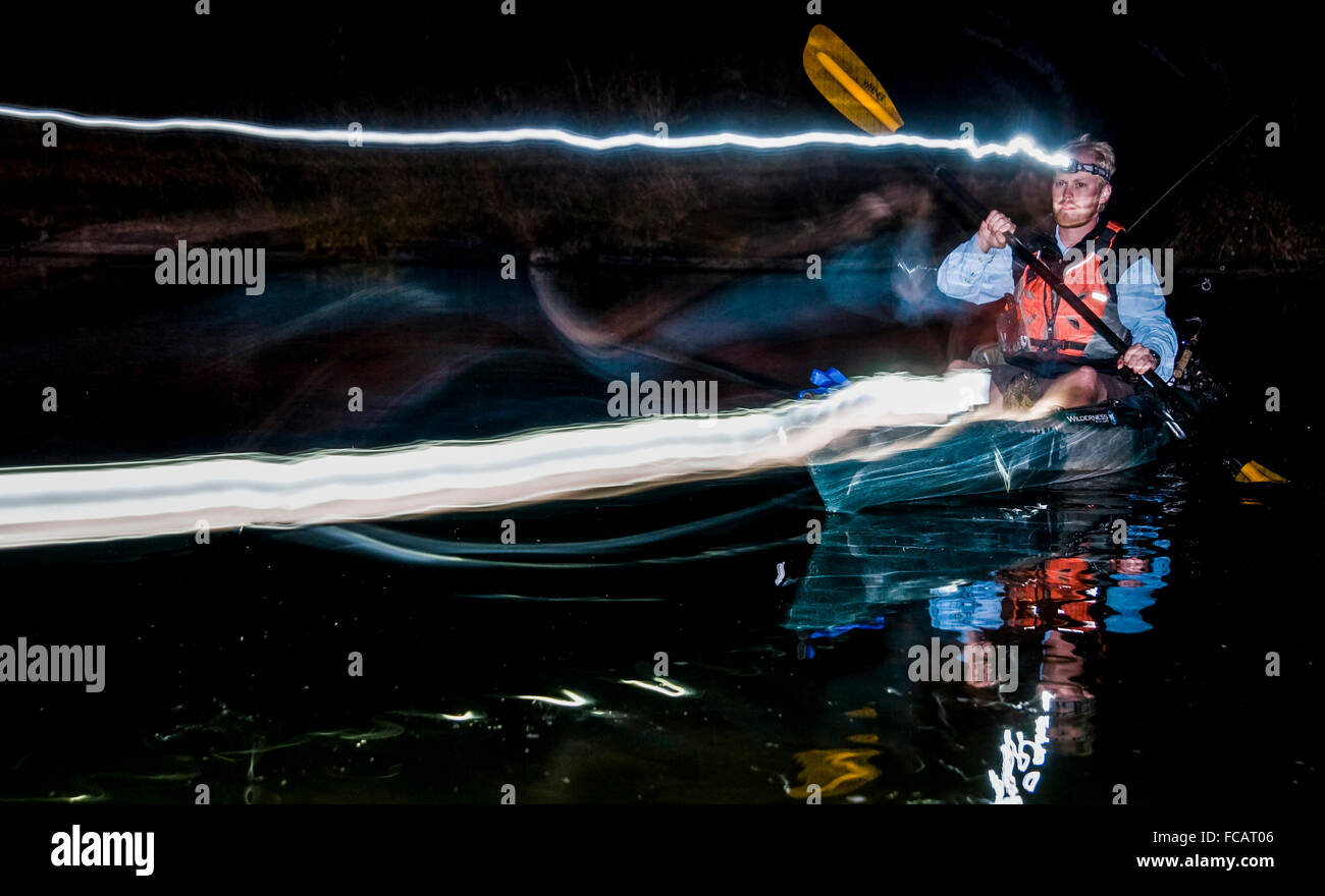 Paddling at night with headlamps Stock Photo