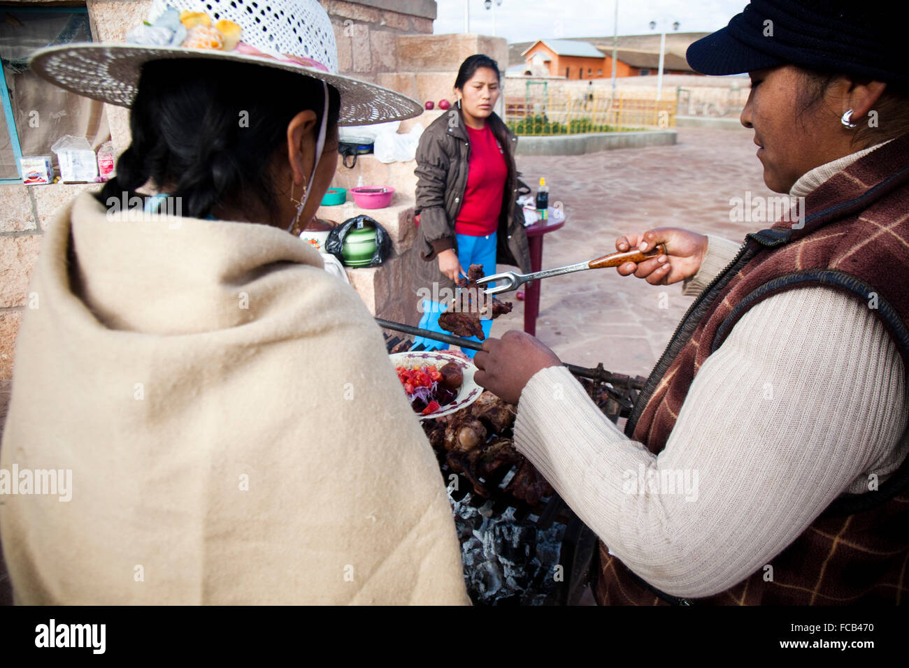 Bolivian women grill at a community park near Uyuni, Bolivia. Stock Photo