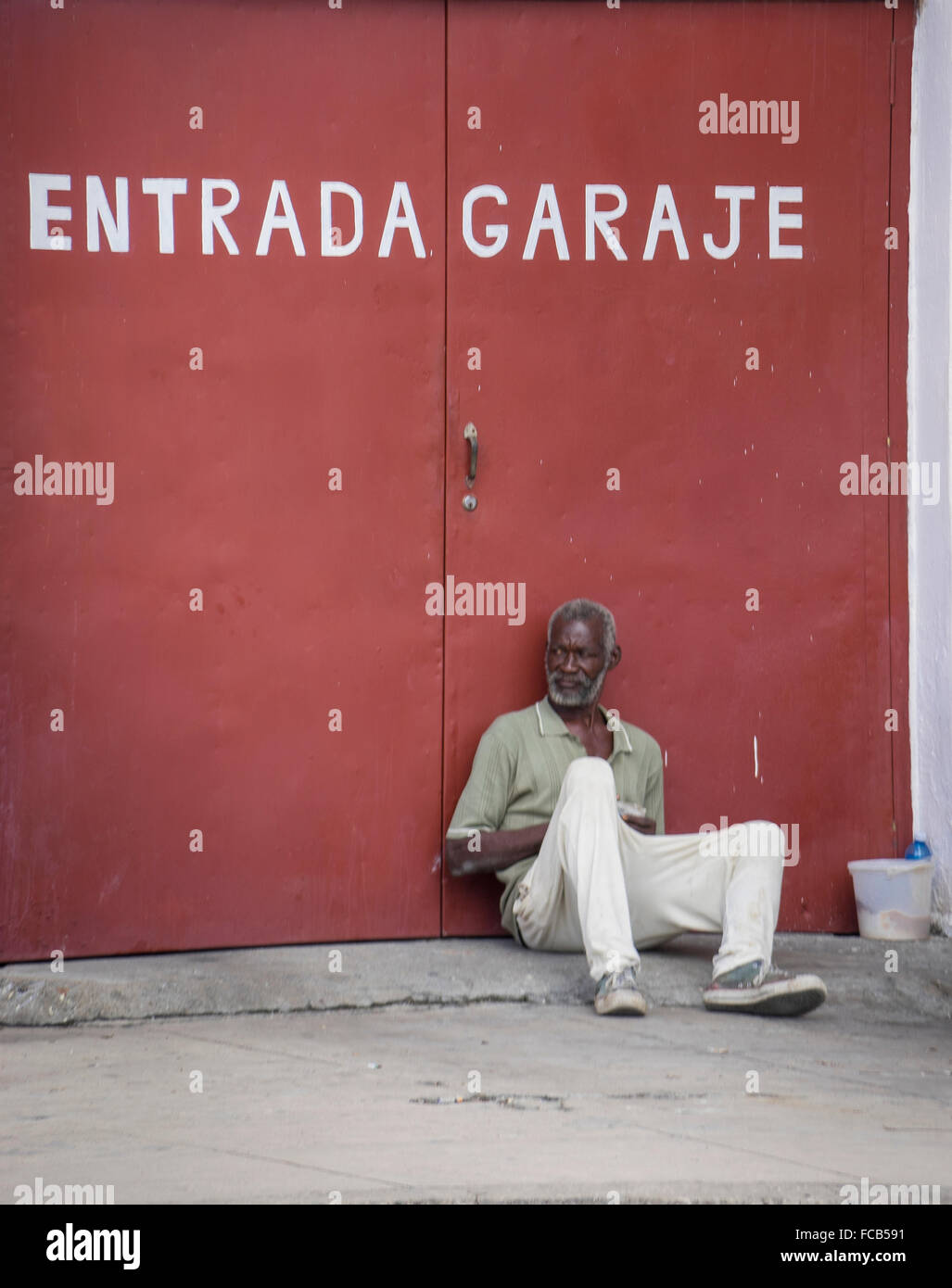 cienfuegos man sitting on the street Stock Photo