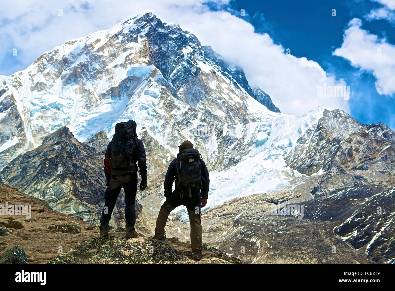Two mountaineers face Ama Dablam in the Nepal Himalayas on their way to Mount Everest Base Camp Stock Photo
