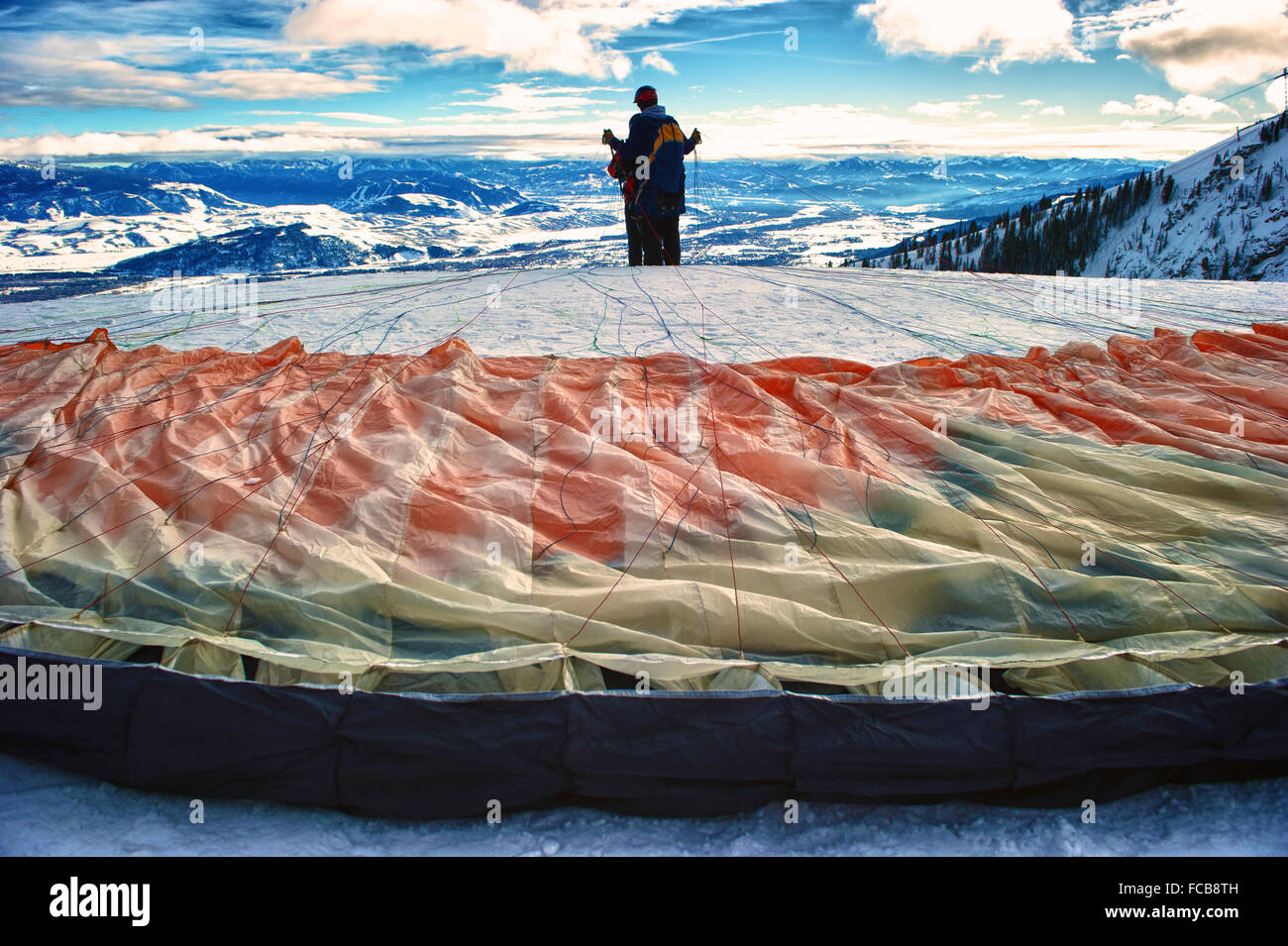 A paraglider prepares to fly above a run at Jackson Hole Ski Resort in