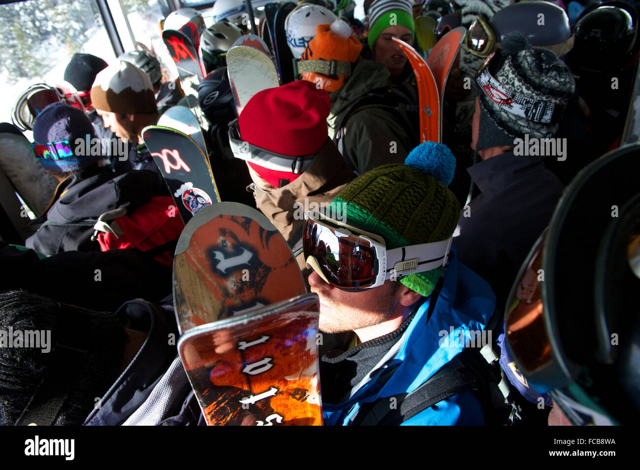Skiiers and snowboarders ride the tram at Jackson Hole, Wyoming. Stock Photo