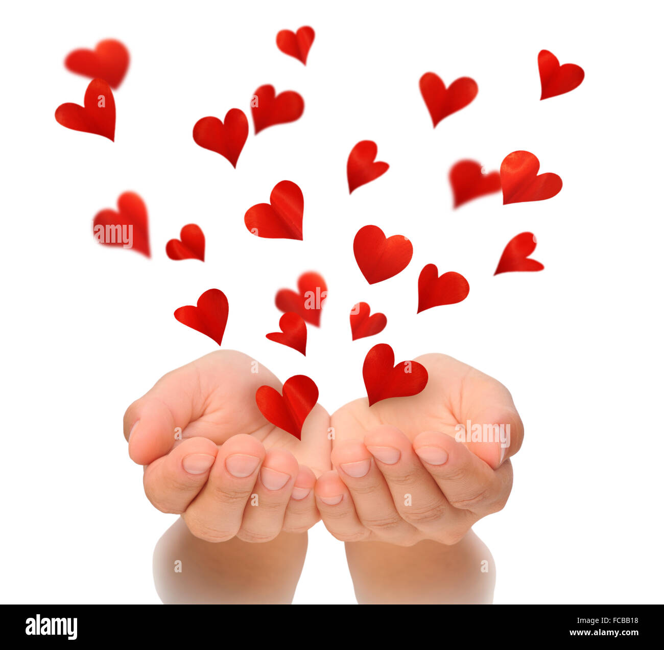 Flying hearts from cupped hands of young woman, Valentine, Valentine's Day, Valentines day, love concept, isolated on white Stock Photo