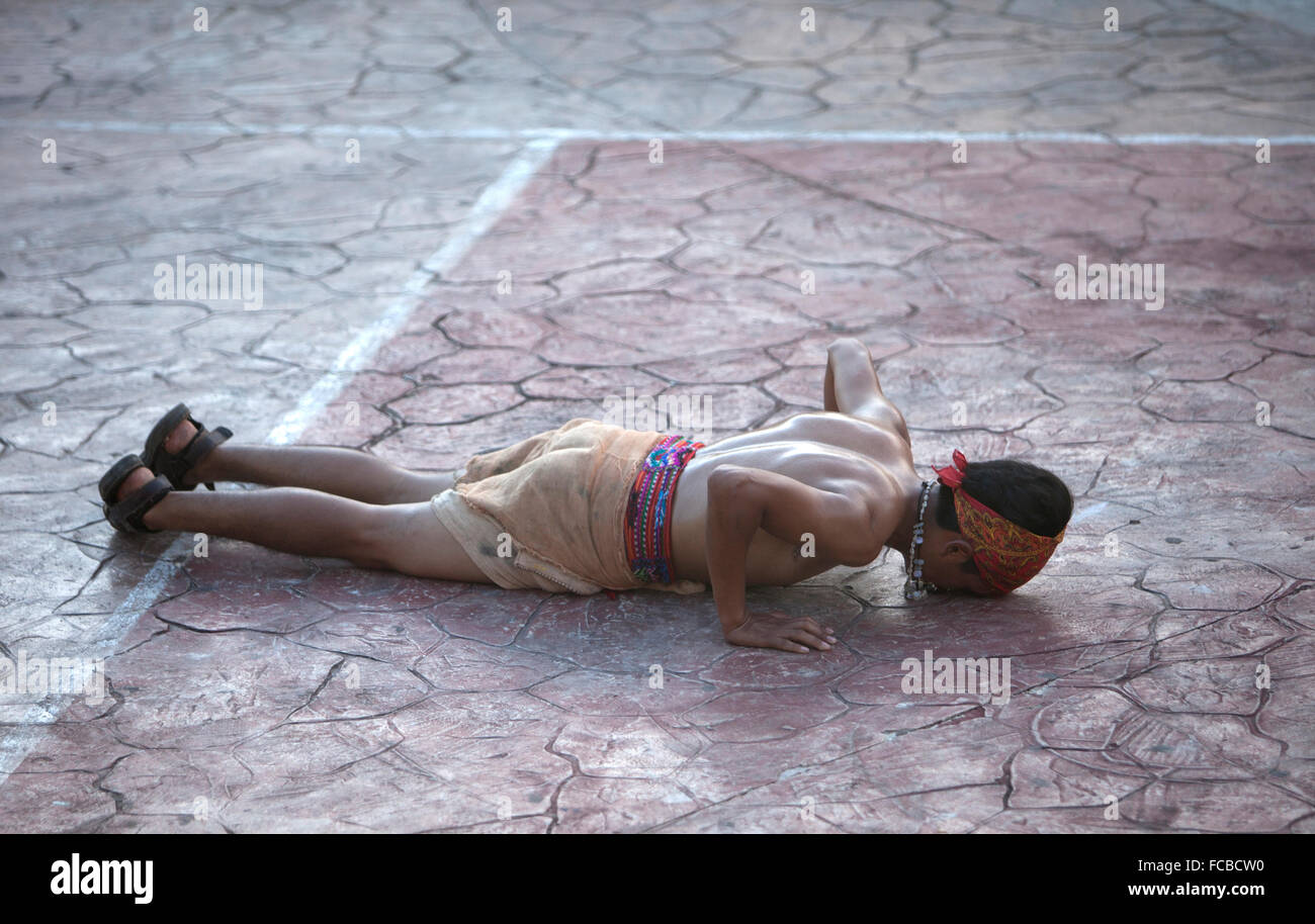 A Mayan Ball Player from Guatemala kiss the floor as he  prays at the first ®Pok Ta Pok® World Cup in Piste, Tinum, Yucatan, Stock Photo