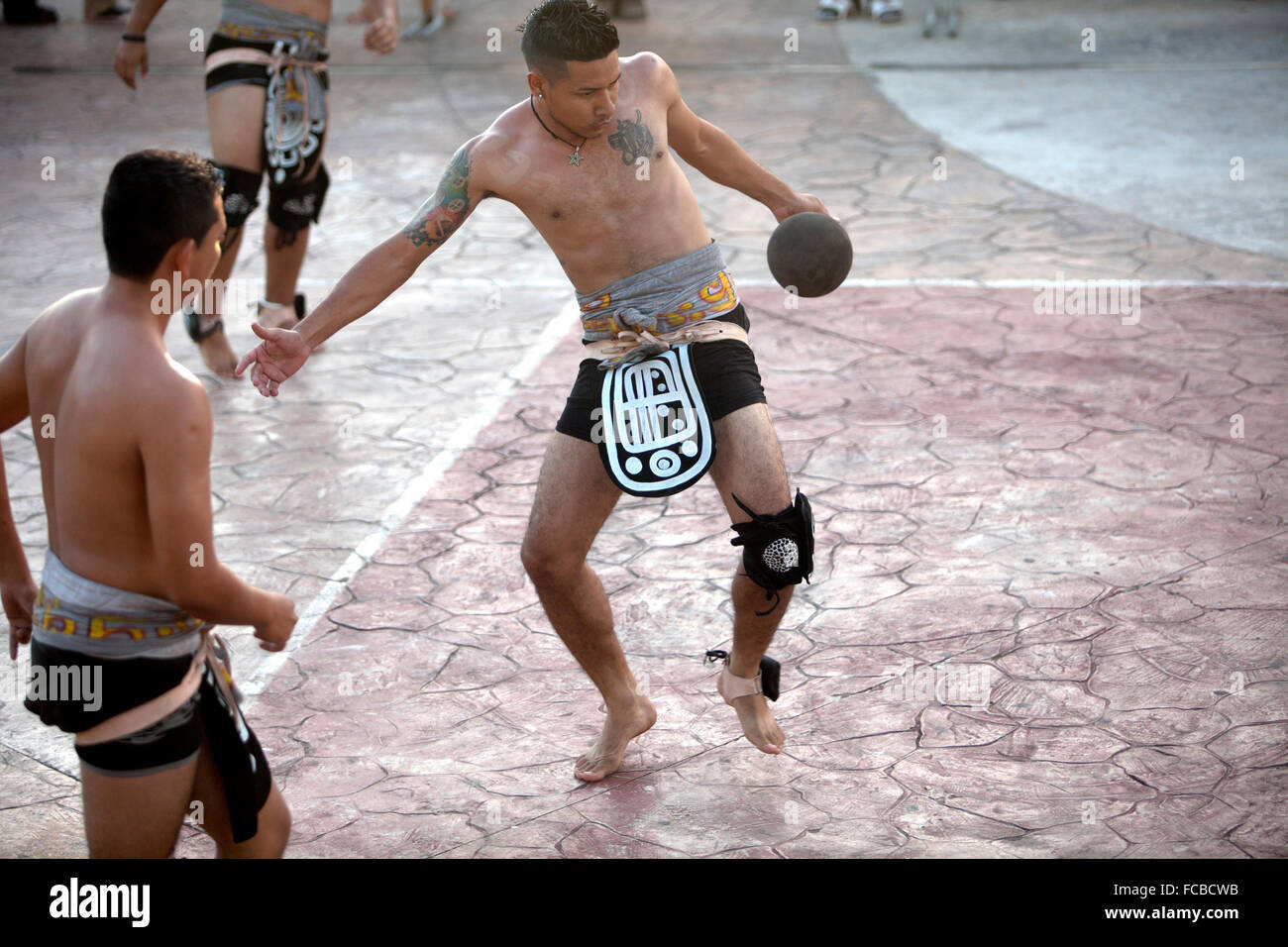 A Mayan Ball Player from 'Ek Balam' team from Yo Creek, Belize, hits the ball with his hip during the first ®Pok Ta Pok® World Stock Photo