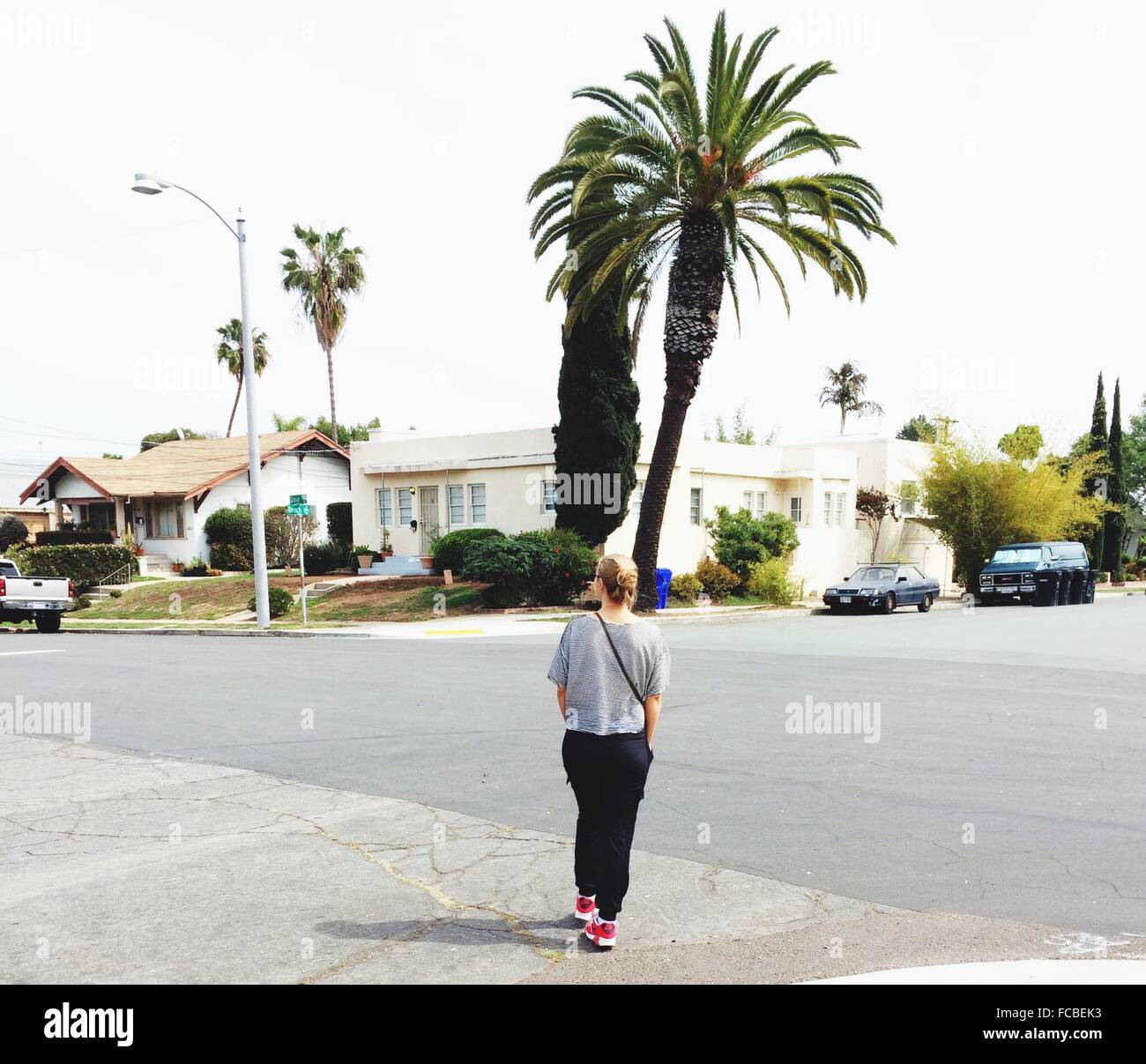 Rear View Of A Woman Standing Walking On Road Stock Photo - Alamy
