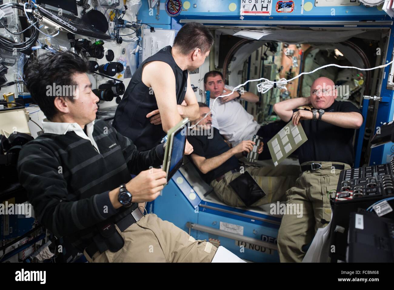 The Expedition 45 crew aboard the International Space Station gather for an emergency situation simulation inside the U.S. Destiny Laboratory October 19, 2015. Crews on the station routinely review and practice procedures that would be used in the event of an emergency. Pictured (left to right) is JAXA astronaut Kimiya Yui, Russian cosmonauts Oleg Kononenko, Mikhail Kornienko, and Sergey Volkov, and NASA astronaut and Expedition 45 commander Scott Kelly. Stock Photo