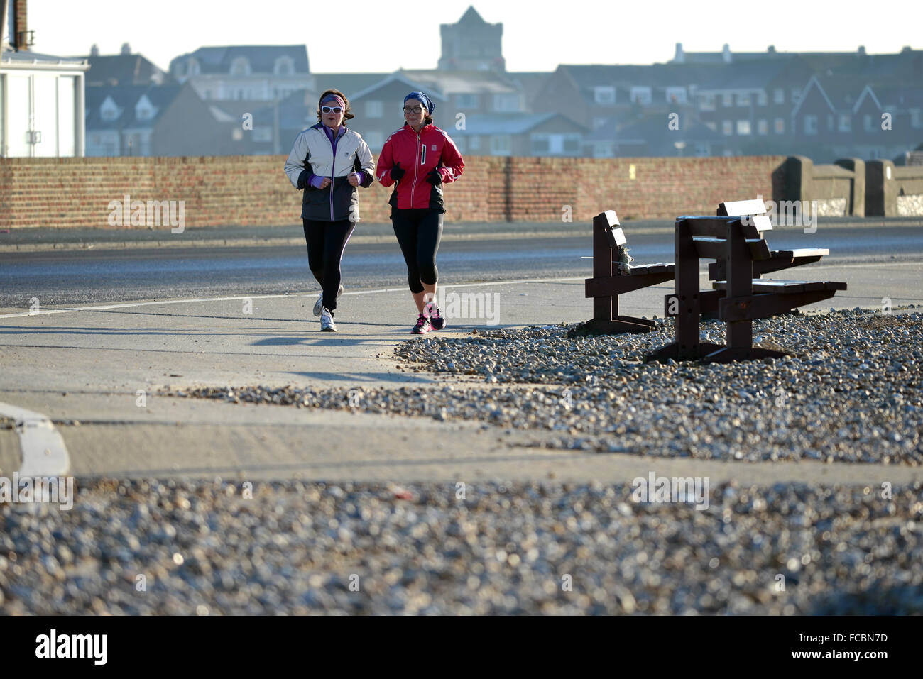 Joggers on Seaford seafront, UK Stock Photo