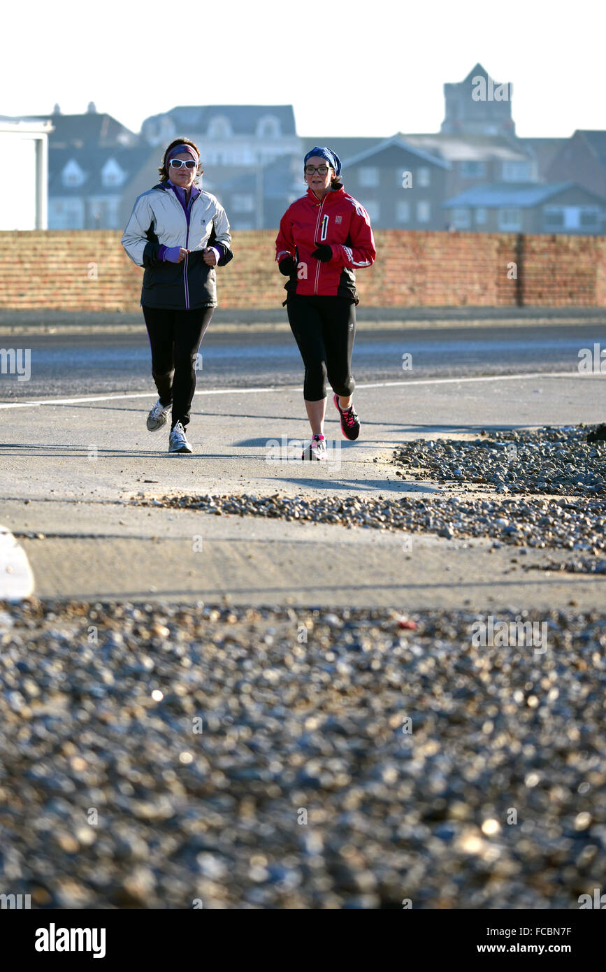 Joggers on Seaford seafront, UK Stock Photo