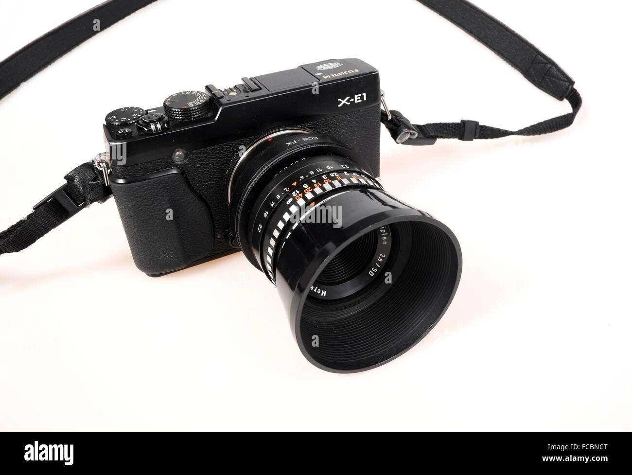 Well used Fuji X-E1 compact system camera fitted with an old East German lens with two adapters to allow it to fit. January 2016 Stock Photo