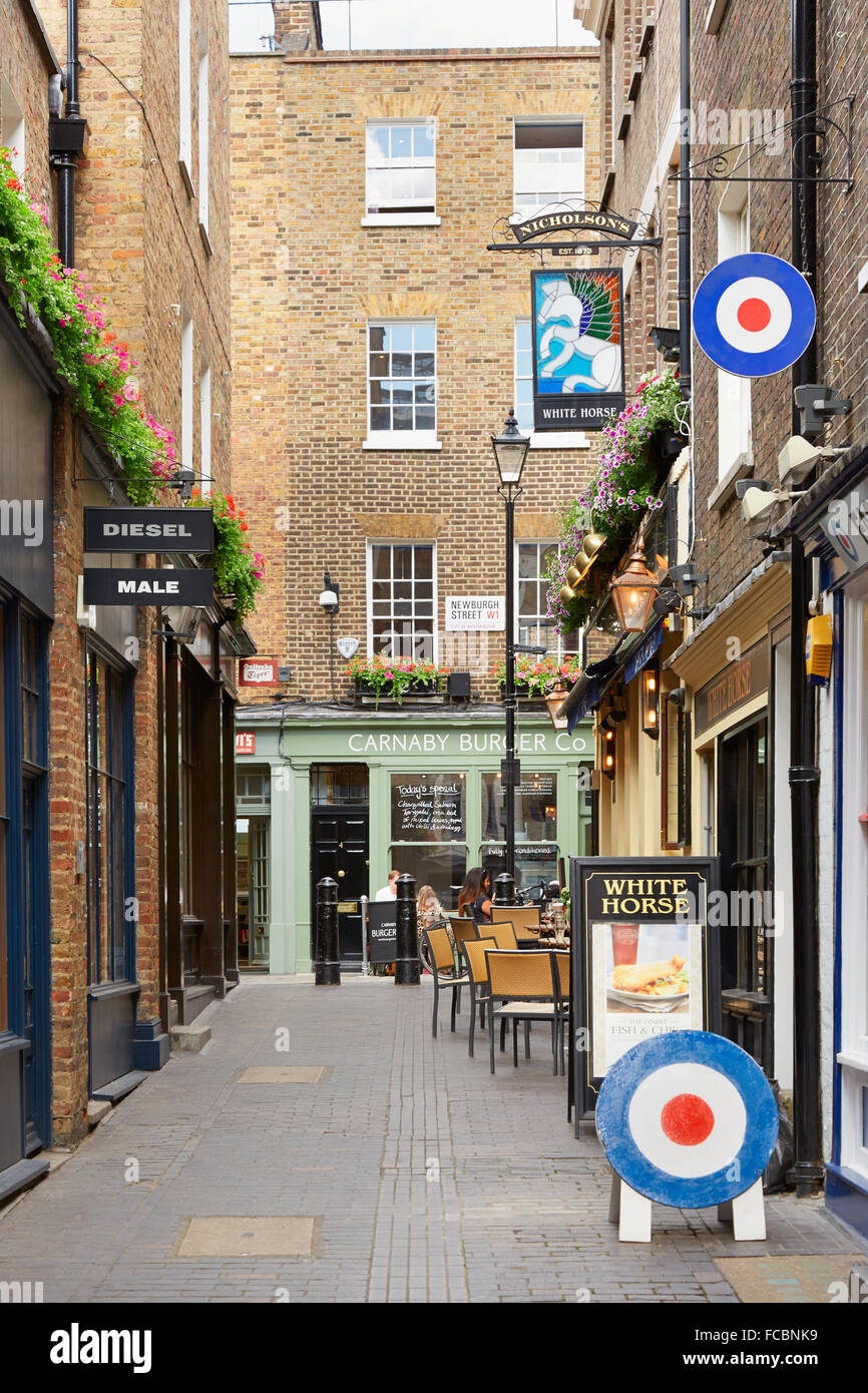 Typical Newburgh street with brick houses and pub near Carnaby street in London, UK Stock Photo