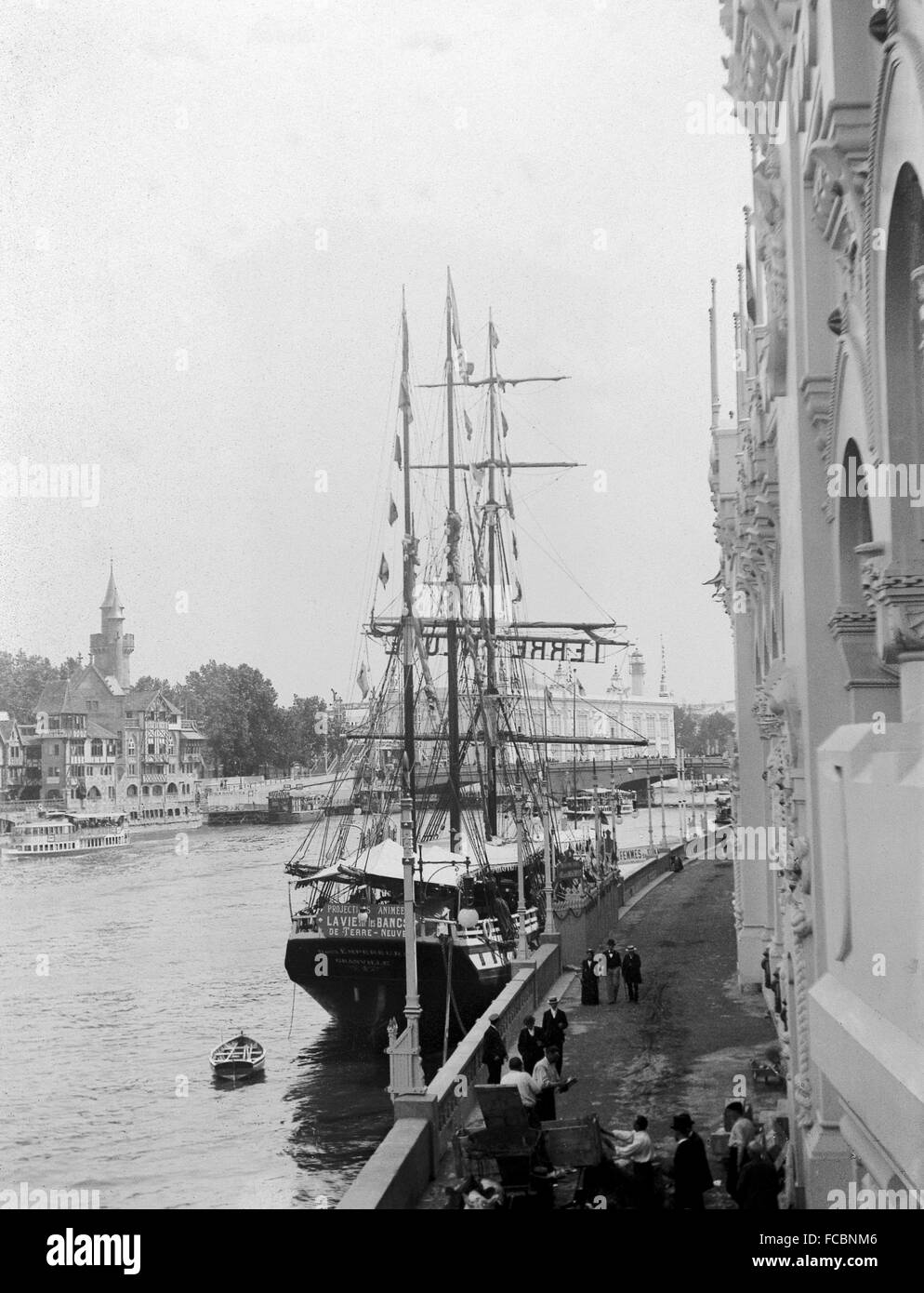 AJAXNETPHOTO. 1900. PARIS, FRANCE. - UNIVERSAL EXPOSITION - WORLD FAIR - THE THREE MASTED SQUARE RIGGED COD FISHING SHIP DEUX EMPEREURS MOORED NEXT TO THE PALACE OF ARMIES ON THE SEINE. IN THE BACKGROUND IS A MODEL OF OLD PARIS BY ARTIST AUBERT ROBIDA.    PHOTO; AJAX VINTAGE PICTURE LIBRARY REF:PAR_EXPO 1900_13. Stock Photo