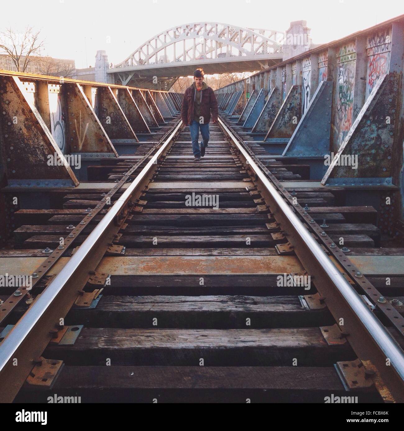 Full Length Of A Young Man Walking On Railway Track Stock Photo Alamy