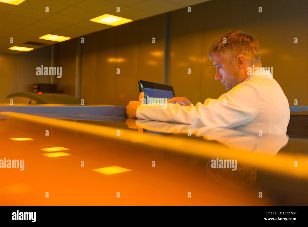 Worker at touch screen in factory Stock Photo