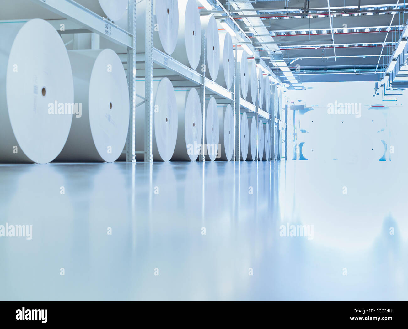 Large spools of paper in printing plant Stock Photo