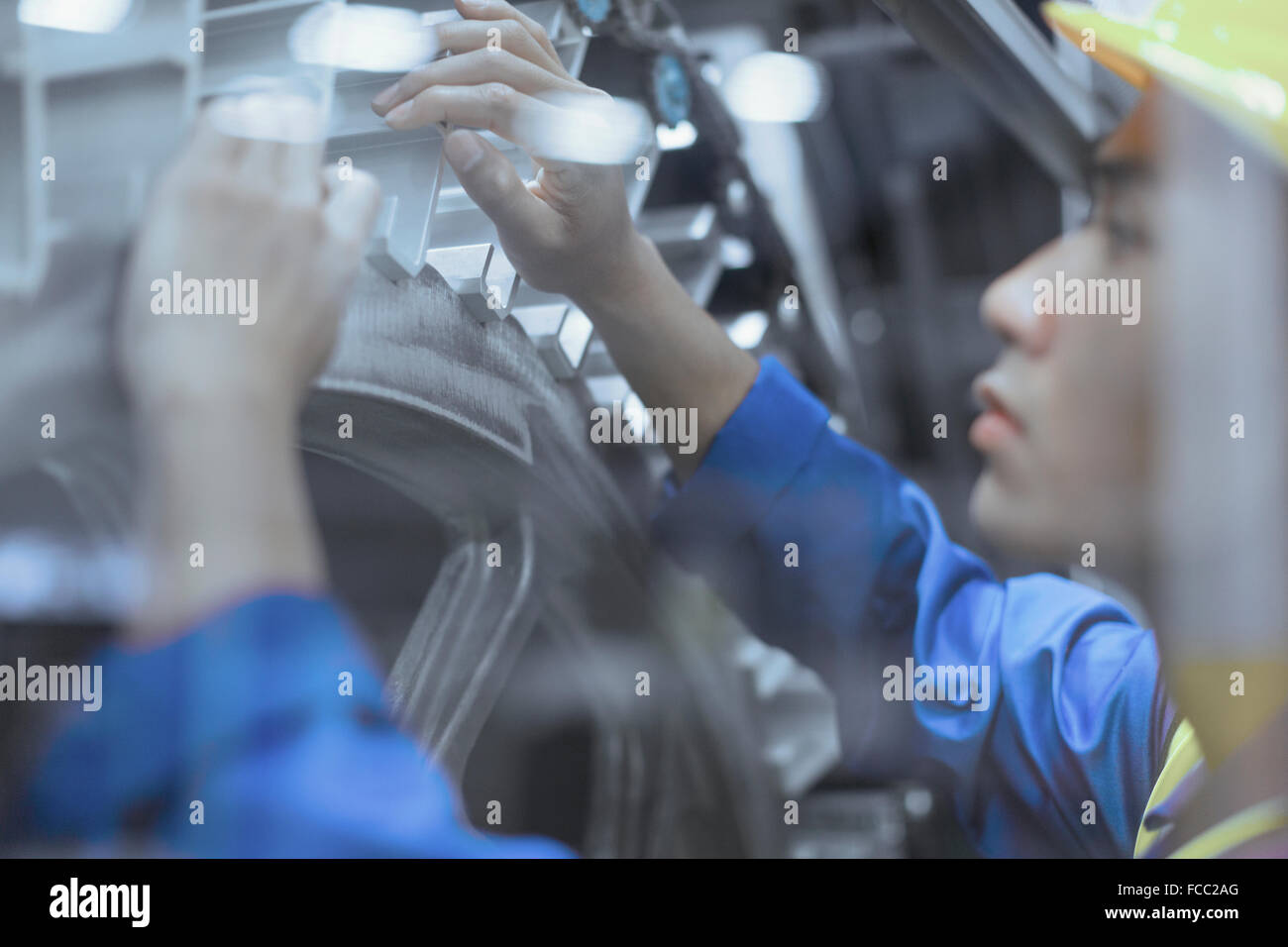 Engineer repairing machinery in factory Stock Photo
