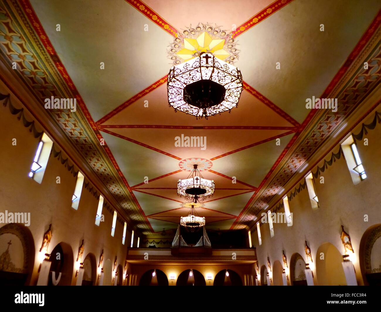 Illuminated Chandelier Hanging On Ceiling In Church Stock Photo
