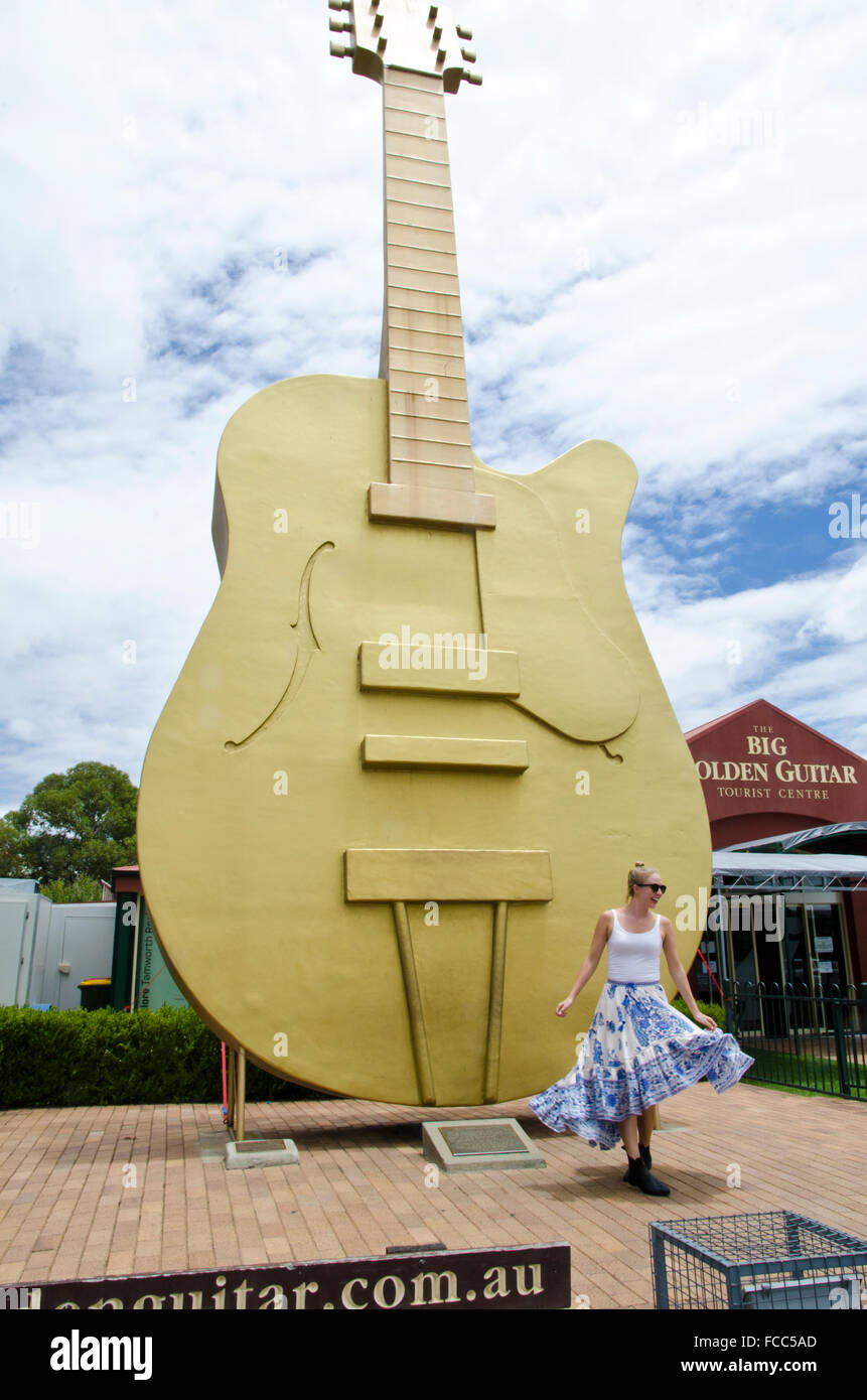 Happy Girl Dancing in front of the Big Guitar at Tamworth NSW Australia Stock Photo