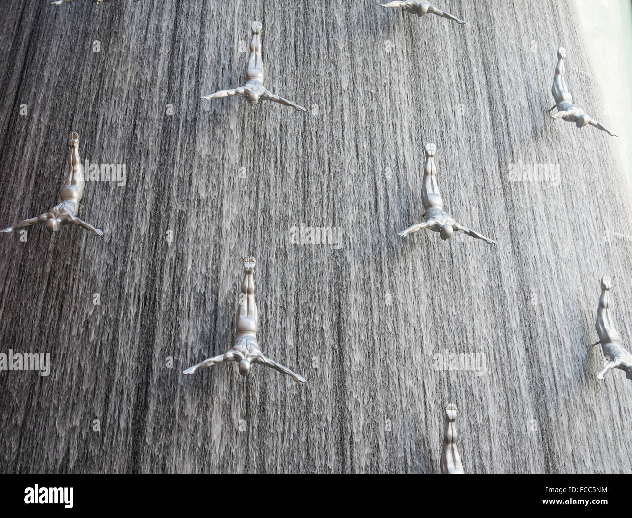 Waterfall And Human Diver Sculpture In Dubai Mall Stock Photo