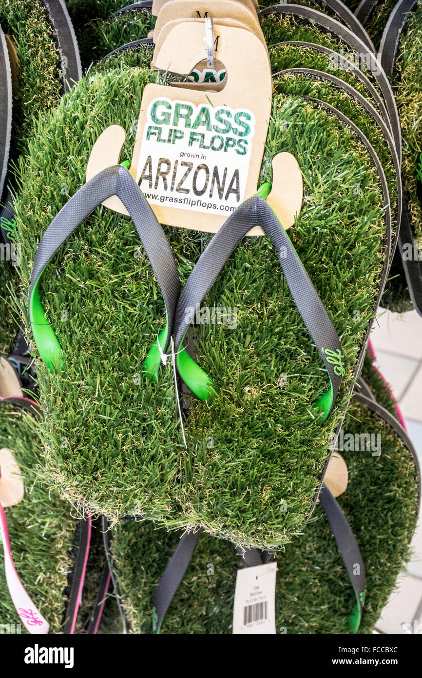 novelty plastic grass flip flops & other tourist tchotchkes displayed for sale in convenience store next to Arizona gas station Stock Photo