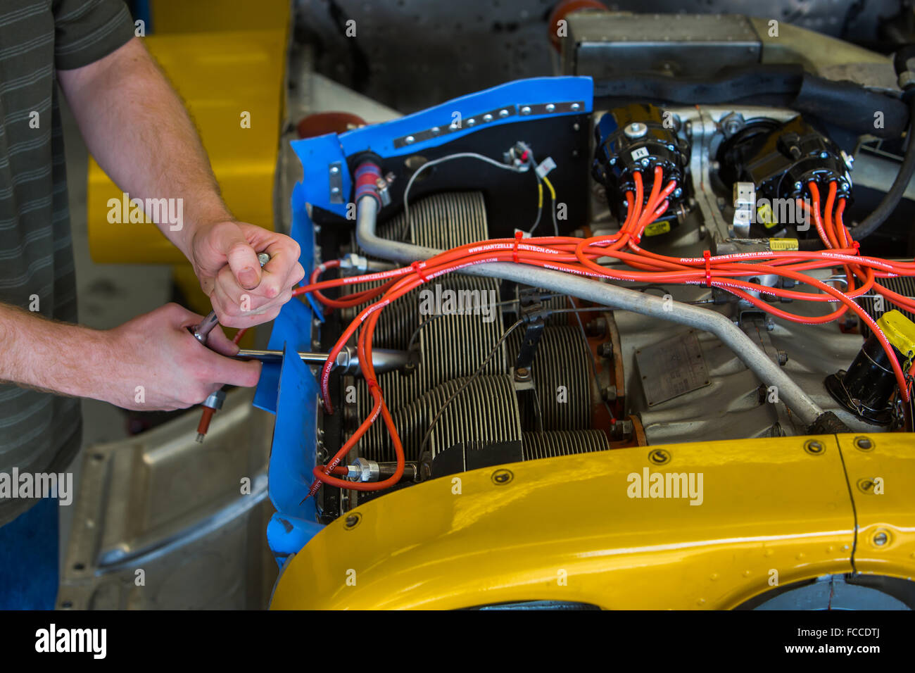 Aviation mechanic working on airplane. Stock Photo