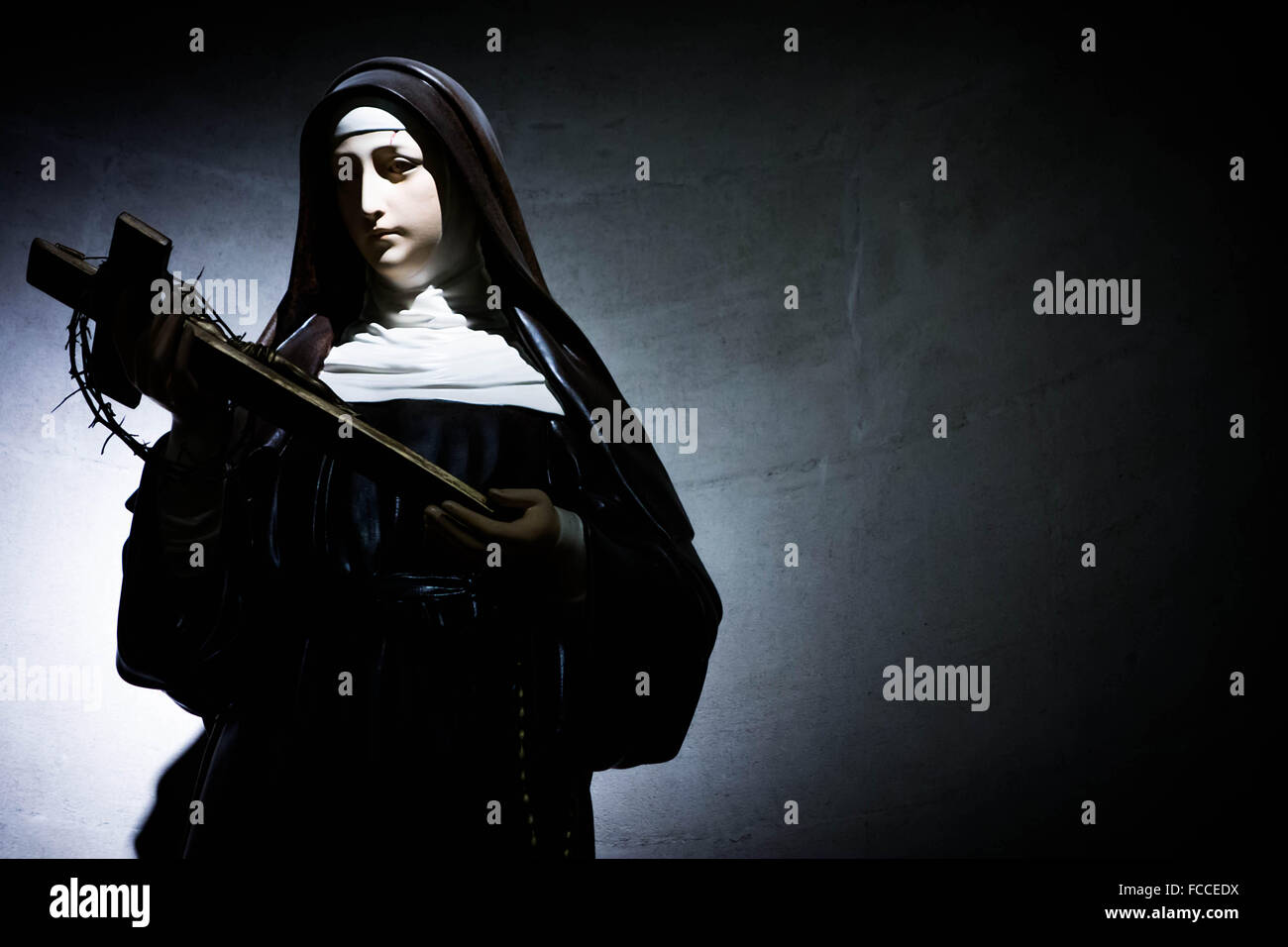 Female Saint Statue Holding The Cross Against Clear Sky Stock Photo Alamy