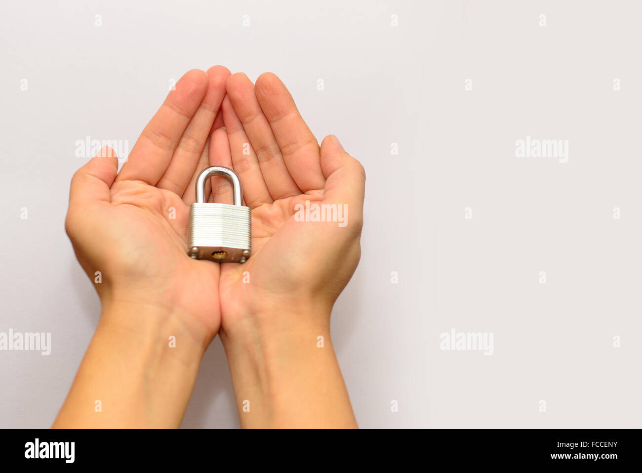 Hand holding the lock Stock Photo - Alamy