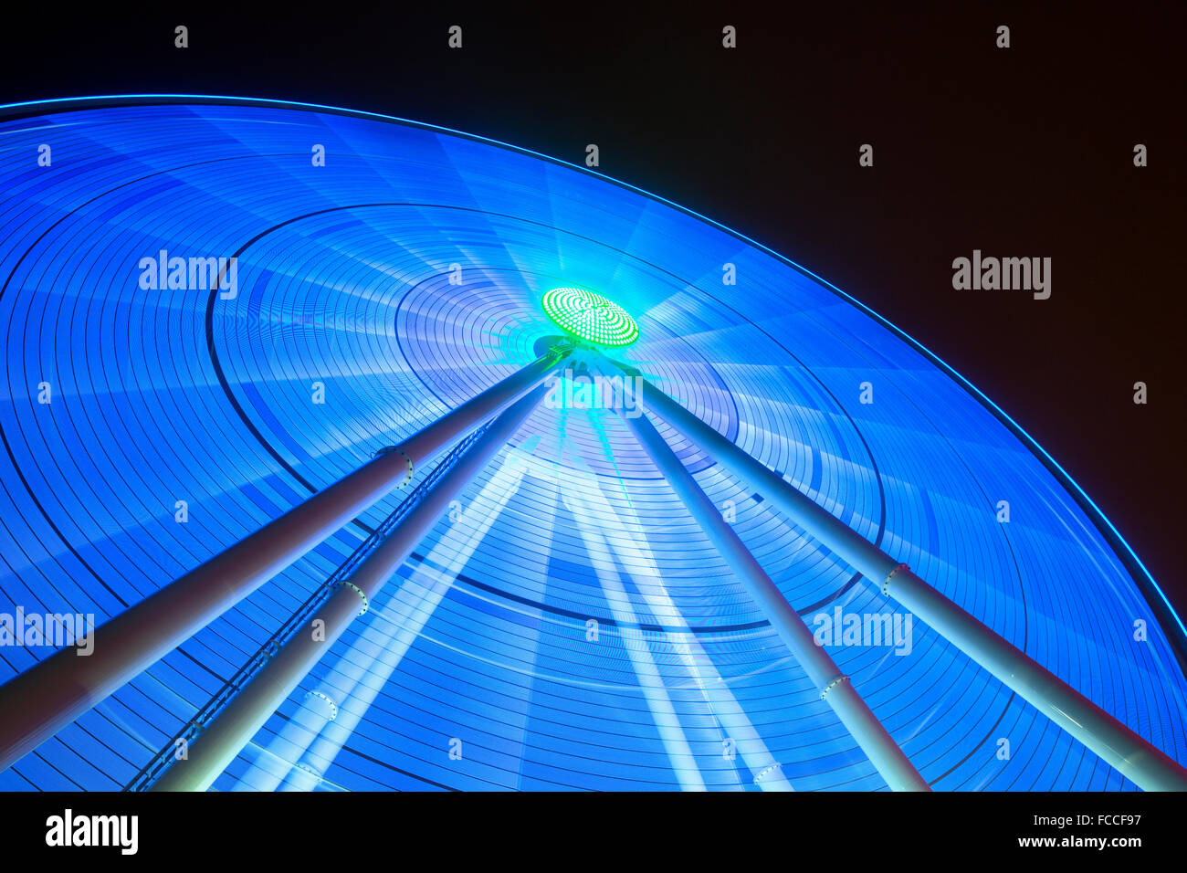 Lights shine from giant spinning wheel Stock Photo Alamy