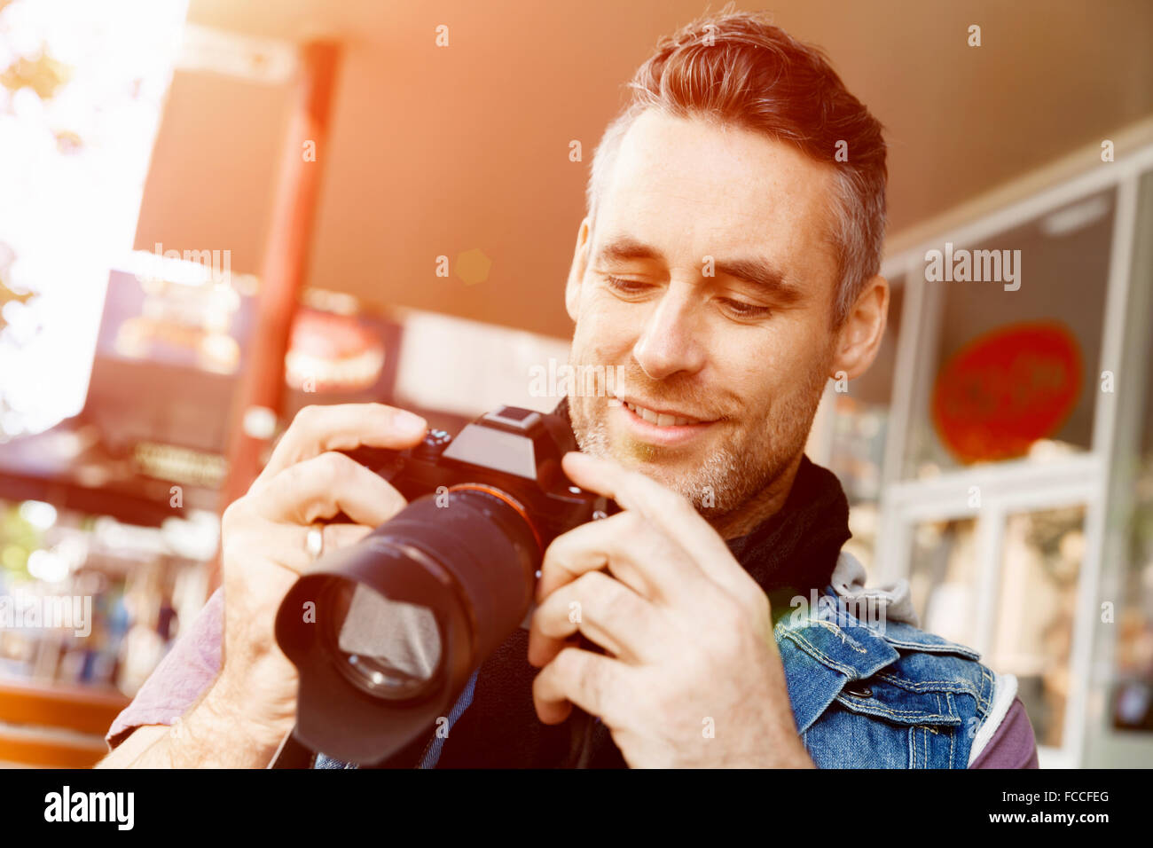 Professional photographer taking picture in city
